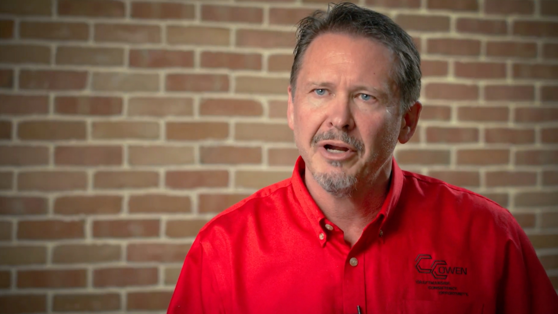 Rod Owen from CC Owen Tile speaking during a professional video interview in front of a brick wall background.