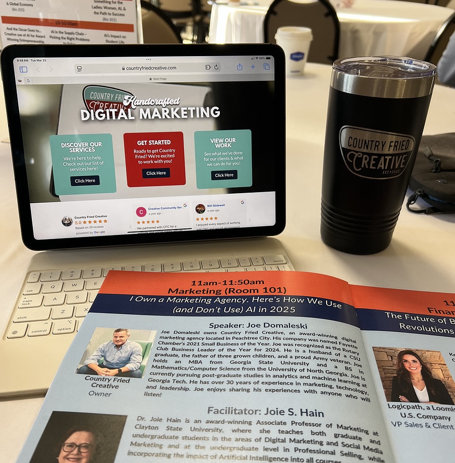 An ipad with the homepage of Country Fried Creative pulled up as well as a shot of a program of speakers featuring Joe Domaleski. 